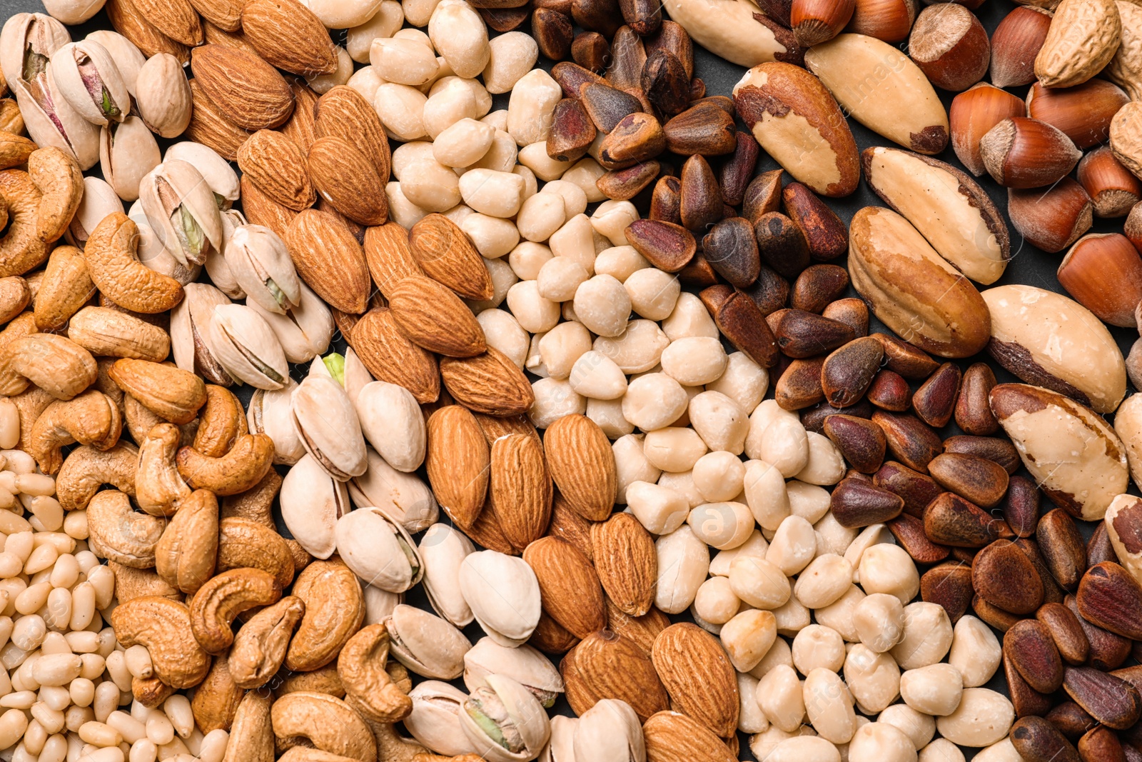 Photo of Organic mixed nuts as background, top view