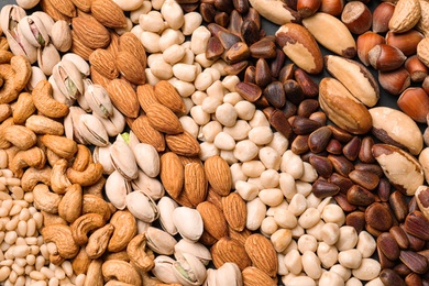 Photo of Organic mixed nuts as background, top view