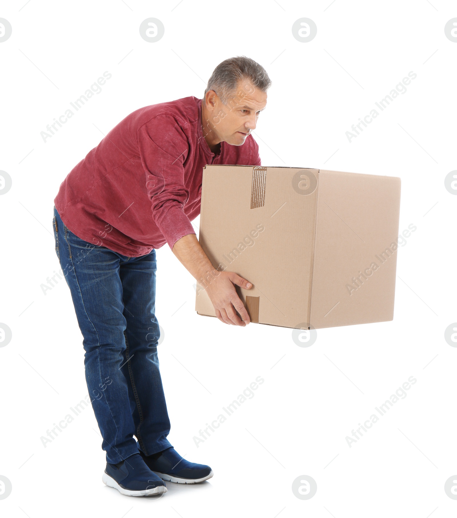 Photo of Full length portrait of mature man lifting carton box on white background. Posture concept