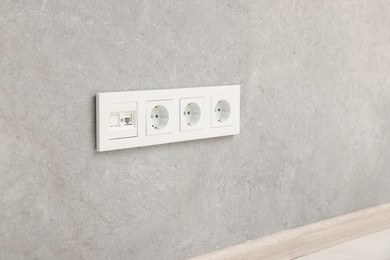 Photo of Wall with power outlet sockets in room. Interior design