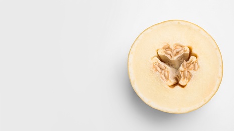 Photo of Half of ripe tasty melon on white background, top view