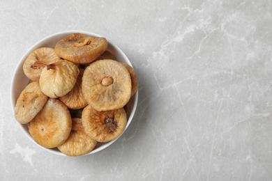 Photo of Tasty dried figs on light grey table, top view. Space for text