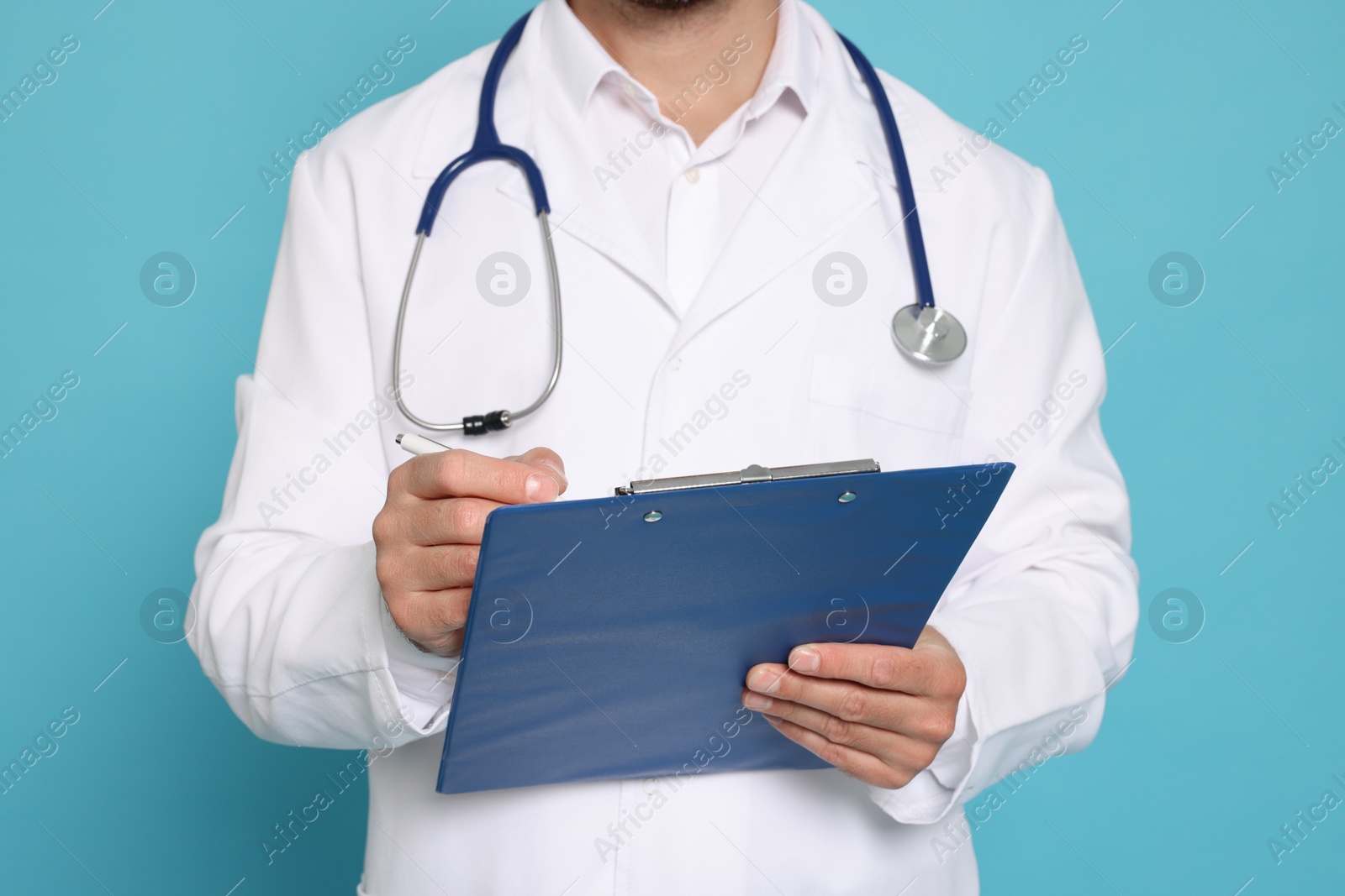 Photo of Doctor with stethoscope and clipboard on light blue background, closeup