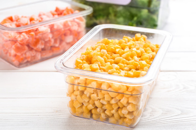 Photo of Different frozen vegetables on white wooden table