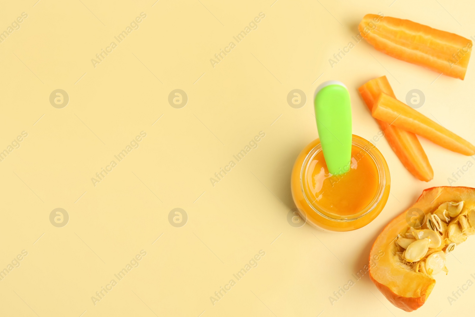 Photo of Flat lay composition with healthy baby food and ingredients on beige background. Space for text