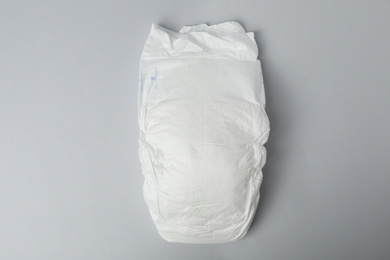 Photo of Baby diaper on grey background, top view