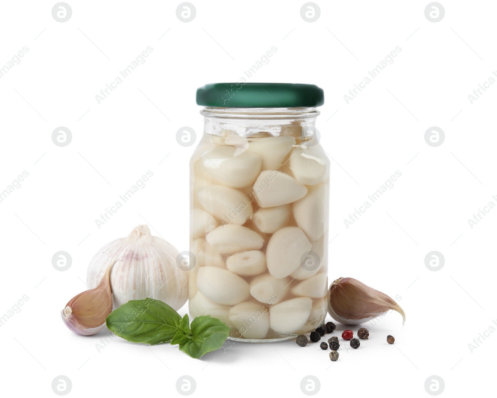 Photo of Composition with jar of pickled garlic on white background