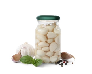 Composition with jar of pickled garlic on white background