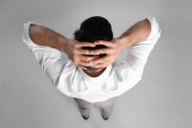 Photo of Businessman in formal clothes on grey background, back view