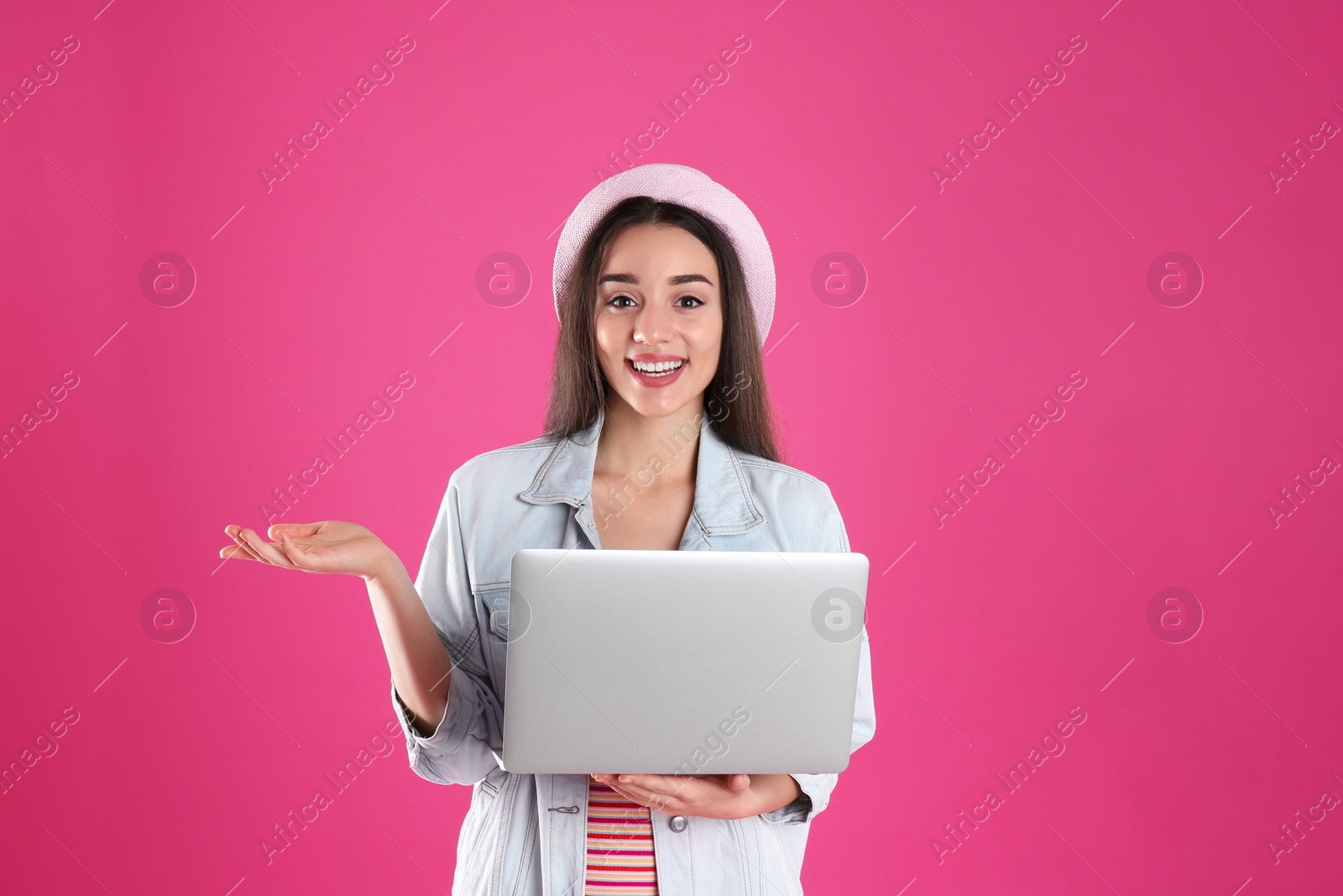 Photo of Portrait of young woman in casual outfit with laptop on color background