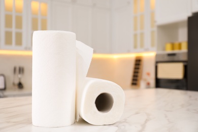 Rolls of paper towels on white table in kitchen