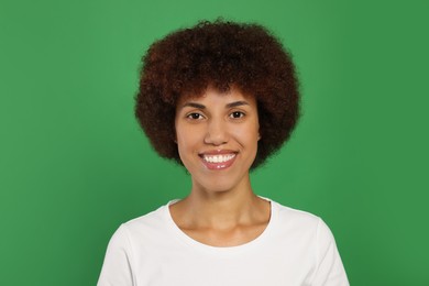 Photo of Portrait of happy young woman on green background