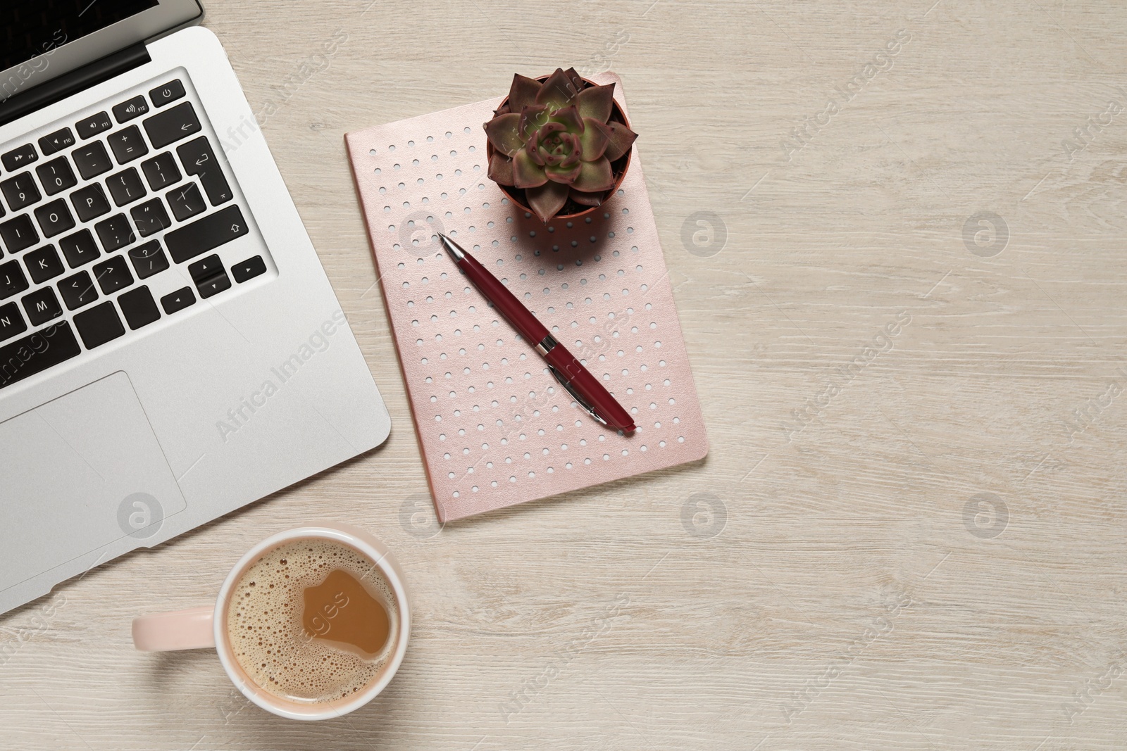 Photo of Modern laptop, houseplant, notebook and cup of coffee on wooden table, flat lay. Space for text