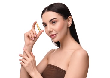 Beautiful young woman holding skincare ampoule on white background