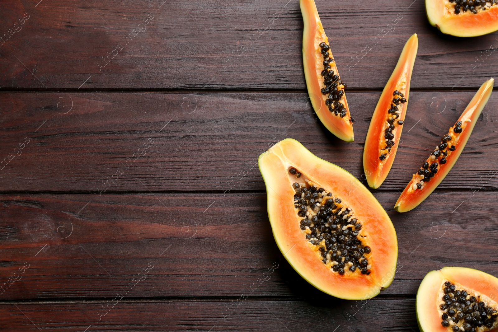 Photo of Fresh ripe papaya on wooden table, flat lay. Space for text