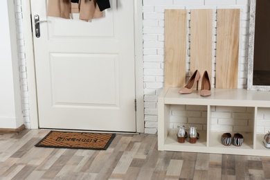 Photo of Hallway interior with shoe rack and mat near door