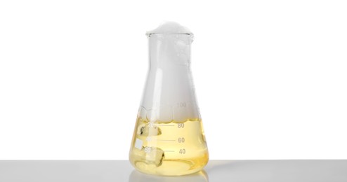 Laboratory flask with colorful liquid isolated on white. Chemical reaction