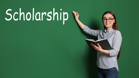 Image of Scholarship concept. Happy student with book and chalk on green background