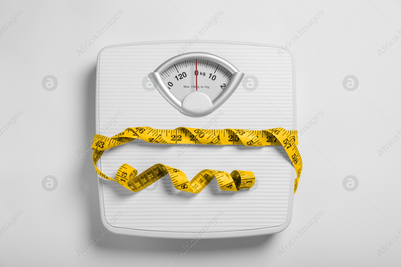 Photo of Weight loss concept. Scales and measuring tape on white background, top view