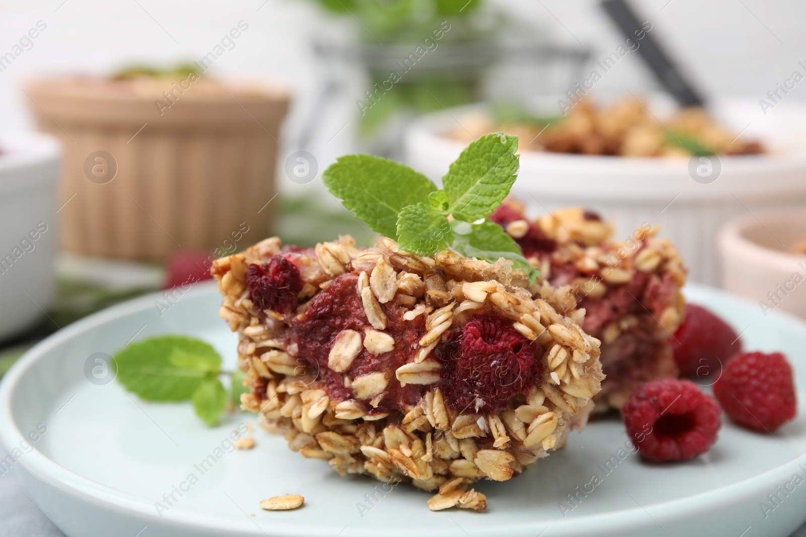 Photo of Tasty baked oatmeal with raspberries on table, closeup