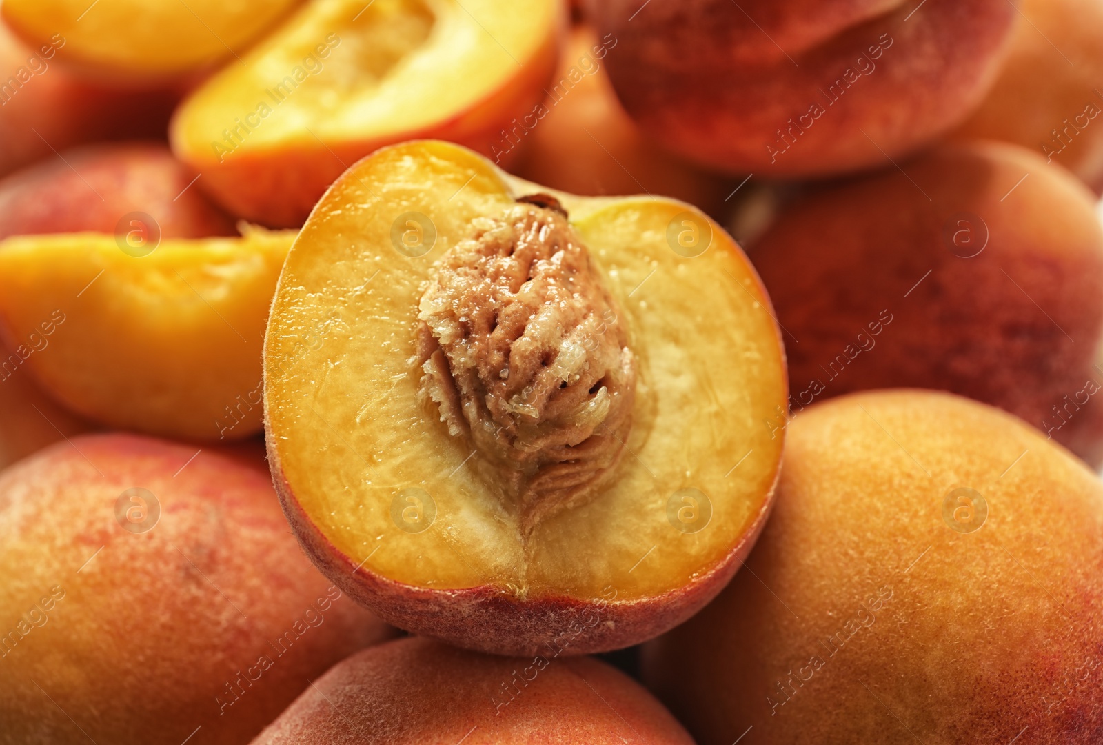 Photo of Pile of delicious ripe peaches as background, closeup