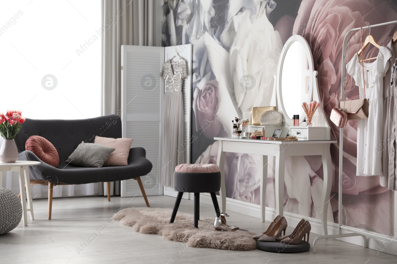 Photo of Stylish room interior with elegant dressing table, sofa and floral wallpaper