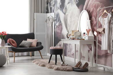 Photo of Stylish room interior with elegant dressing table, sofa and floral wallpaper