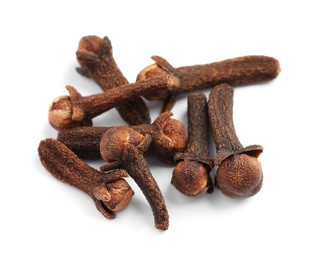 Photo of Pile of aromatic dry cloves on white background