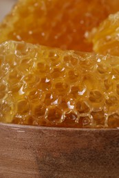 Photo of Natural honeycombs on wooden board, closeup view