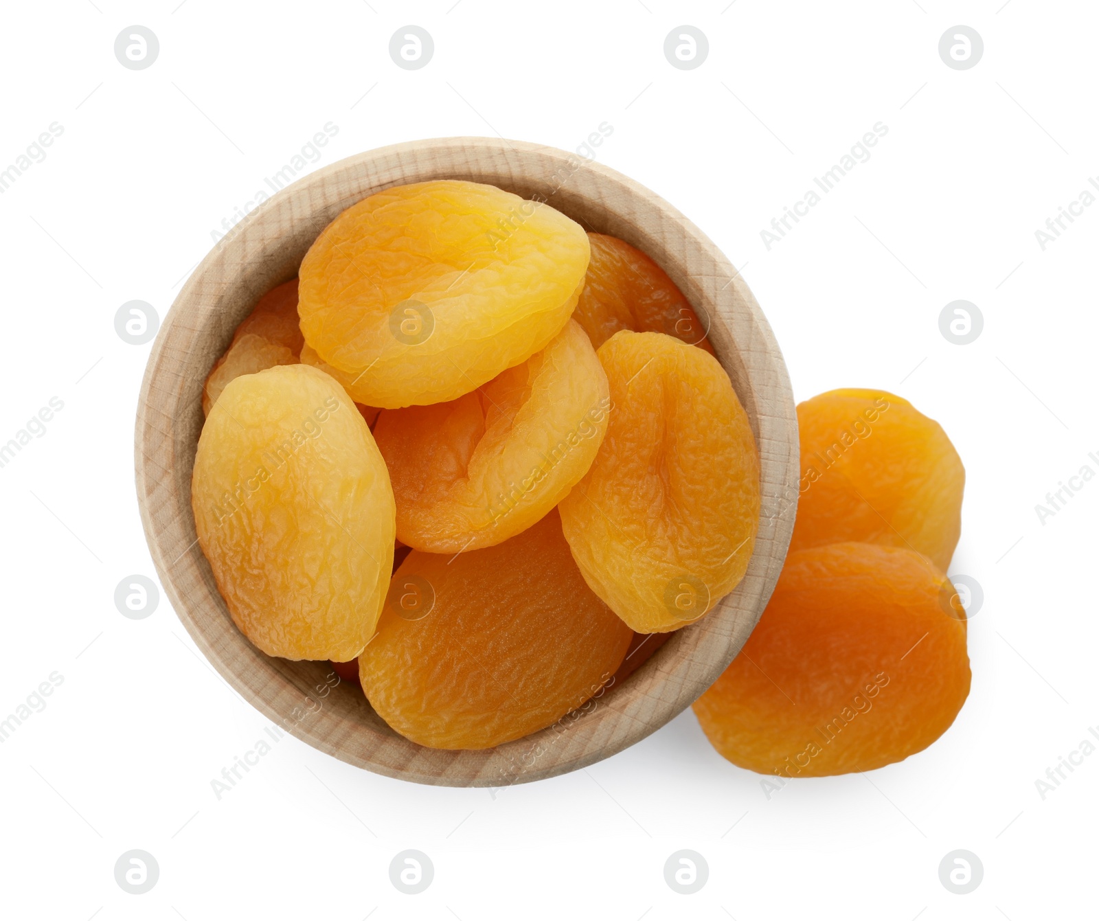 Photo of Ceramic bowl with tasty dried apricots isolated on white, top view