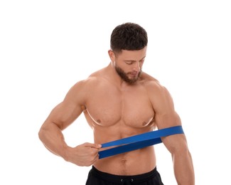 Young man exercising with elastic resistance band on white background