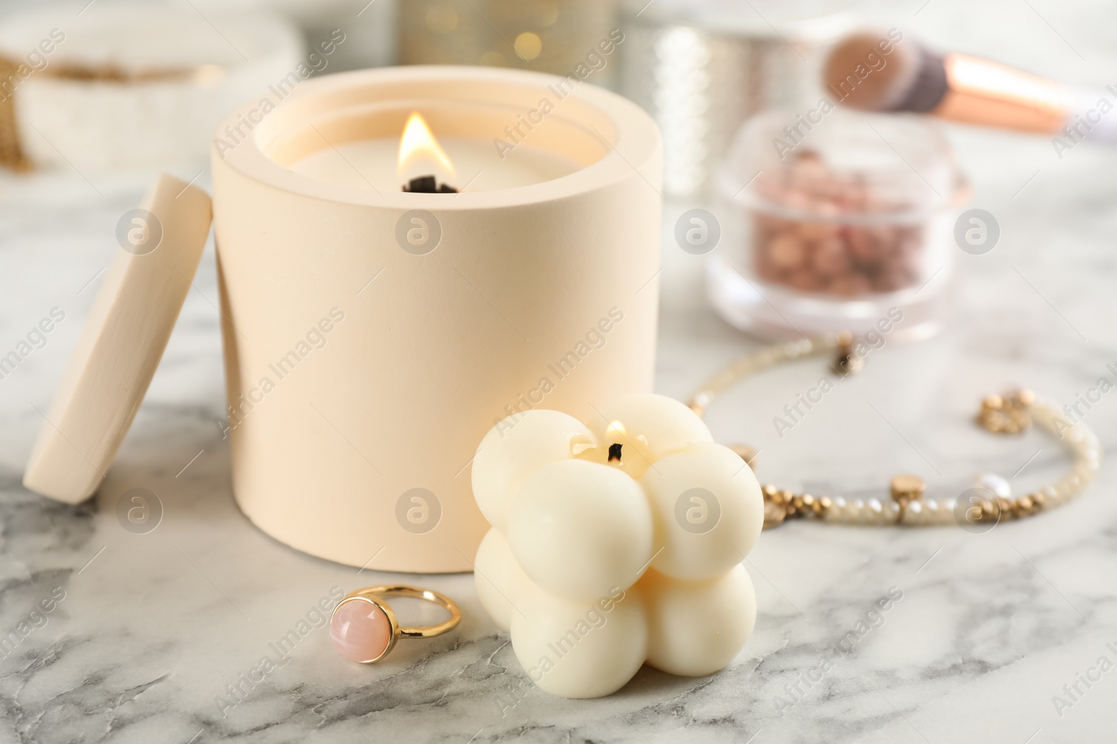 Photo of Composition with burning soy candles on white marble table