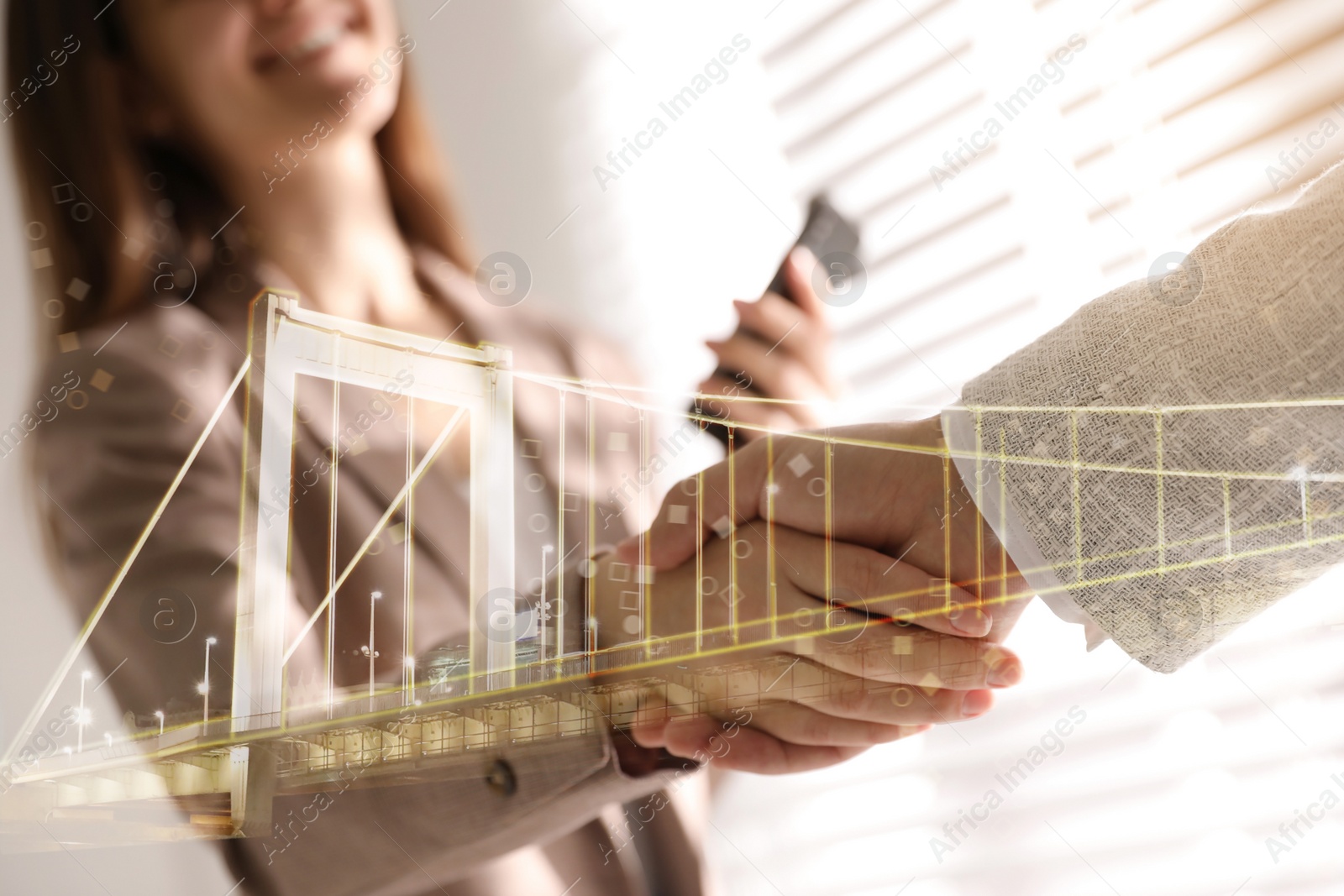 Image of Double exposure of bridge and business partners shaking hands indoors, closeup