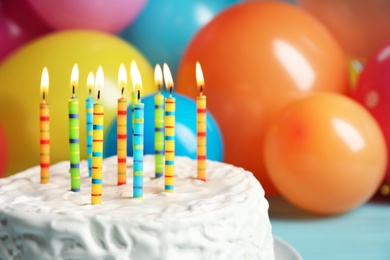 Photo of Delicious birthday cake with burning candles, closeup