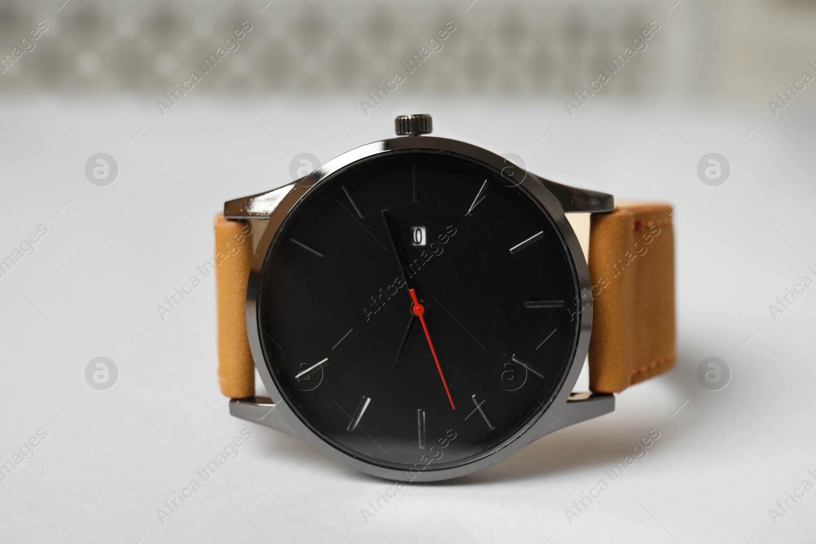 Photo of Stylish wrist watch on table. Fashion accessory