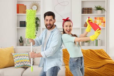 Spring cleaning. Couple with spray and mop in living room