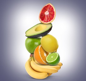 Image of Stack of different fresh fruits on pale greyish blue gradient background