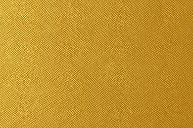 Texture of golden leather as background, closeup