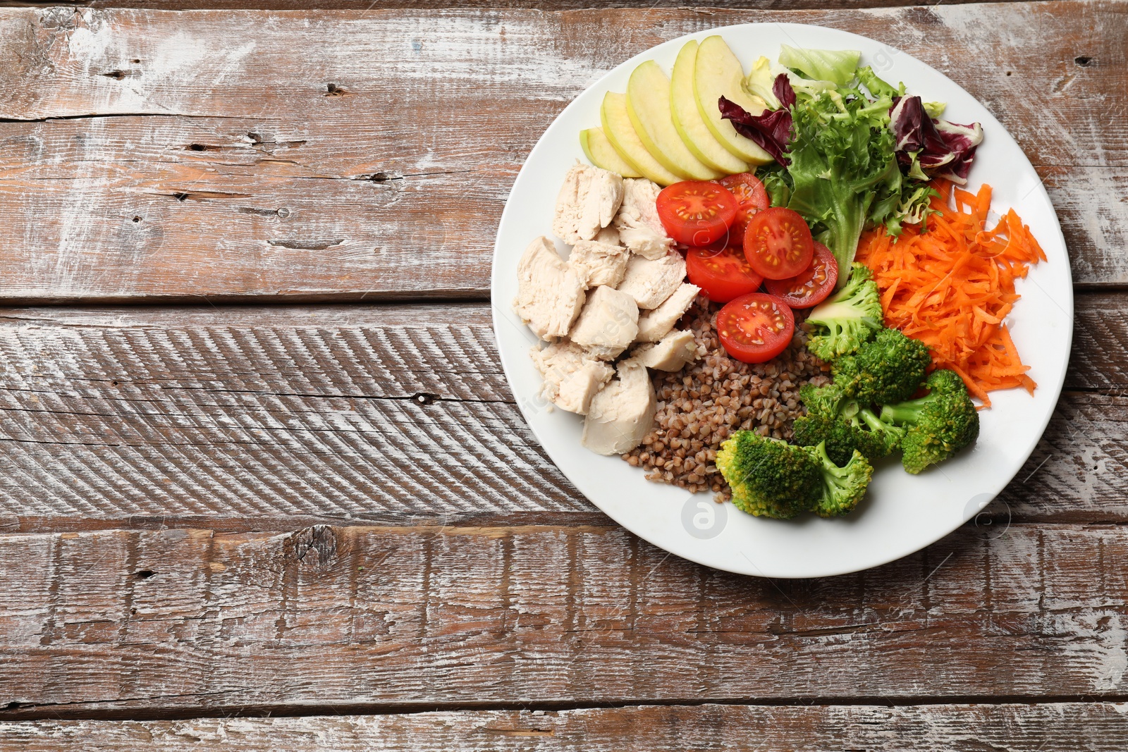 Photo of Balanced diet and healthy foods. Plate with different delicious products on wooden table, top view. Space for text