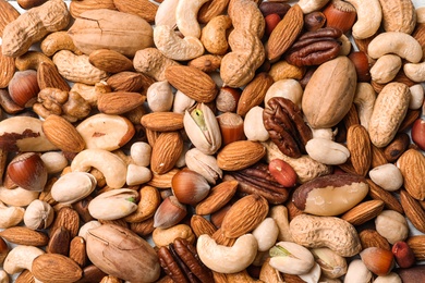 Photo of Organic mixed nuts as background, top view