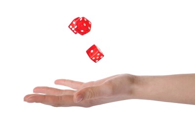 Photo of Woman throwing game dices on white background, closeup