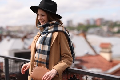 Beautiful woman in warm scarf and hat outdoors