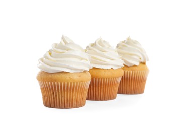 Delicious cupcakes decorated with cream on white background