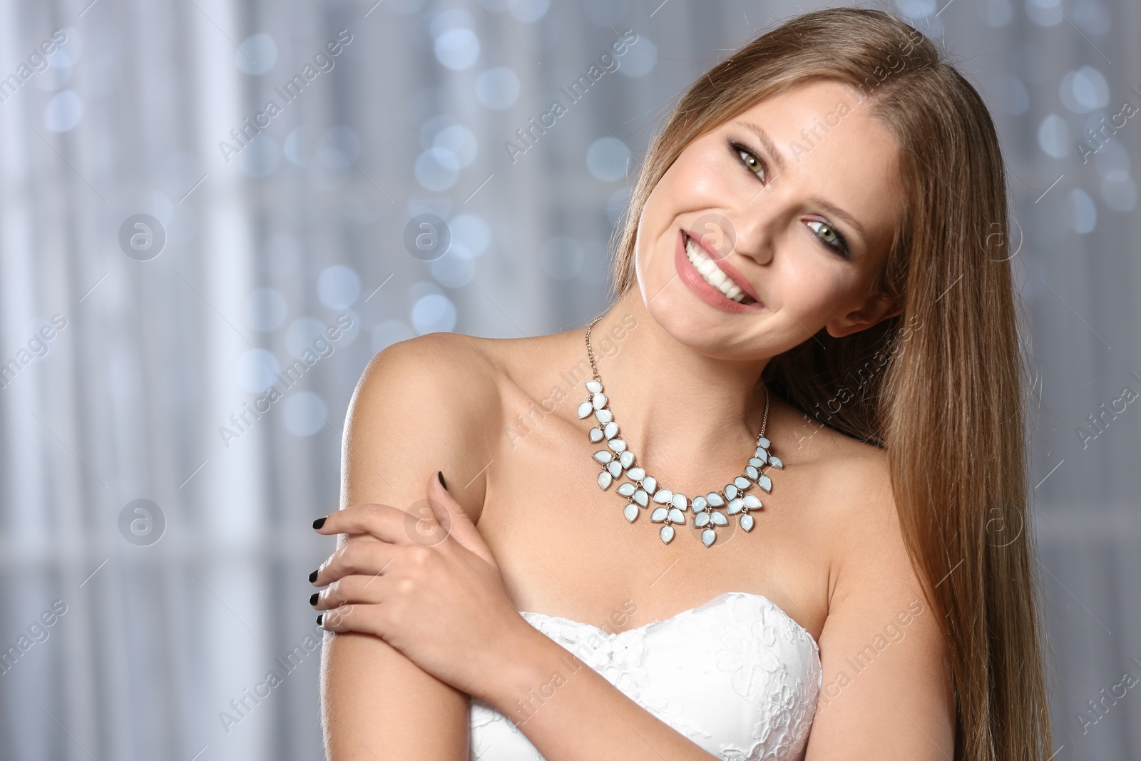 Photo of Beautiful woman with stylish jewelry against blurred lights