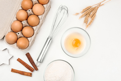 Photo of Flat lay composition with raw eggs and other ingredients on white table. Baking pie