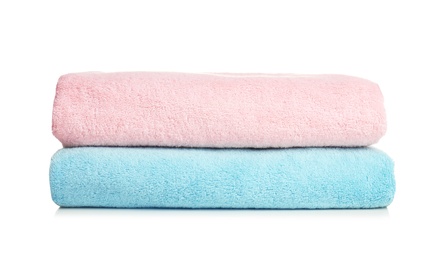 Photo of Folded soft terry towels on white background