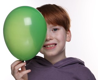 Photo of Boy with green balloon on white background