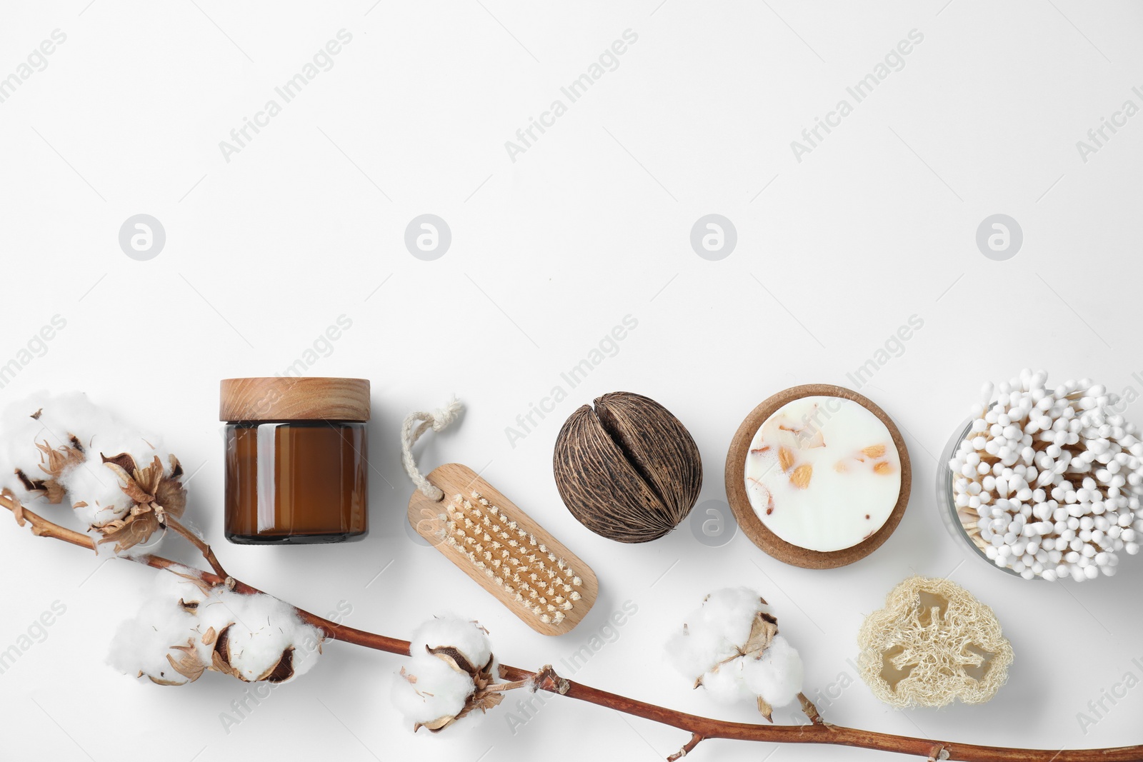 Photo of Bath accessories. Flat lay composition with personal care products and cotton flowers on white background, space for text
