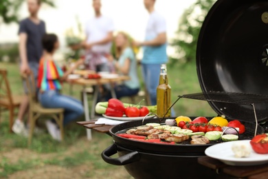 Modern grill with meat and vegetables outdoors, closeup