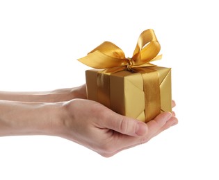 Photo of Woman holding golden gift box on white background, closeup